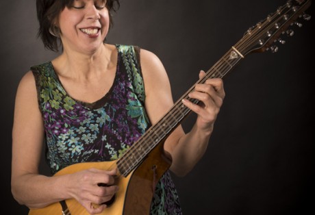 Publicity shot of Carol Coronis playing the cittern